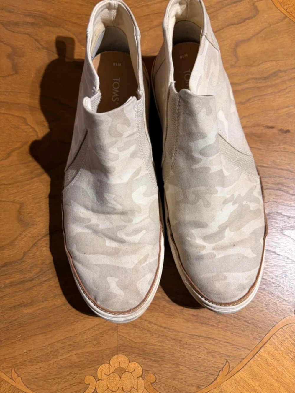 Tom’s white and ivory camo slip on high tops